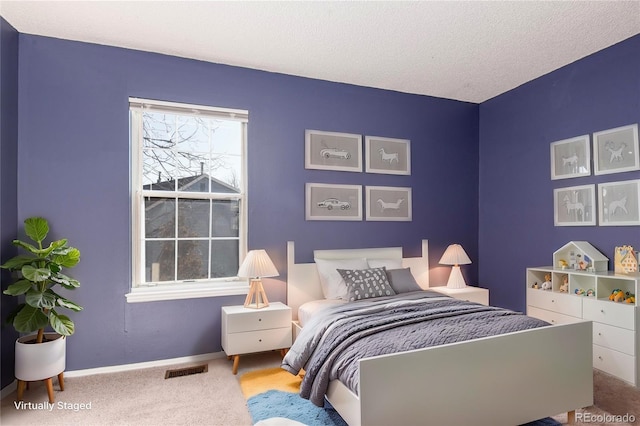 carpeted bedroom featuring a textured ceiling