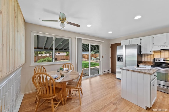 4525 S Cole Ct, Morrison, CO 80465 - kitchen featuring stainless steel appliances, under cabinet range hood, a baseboard heating unit, backsplash, and a center island
