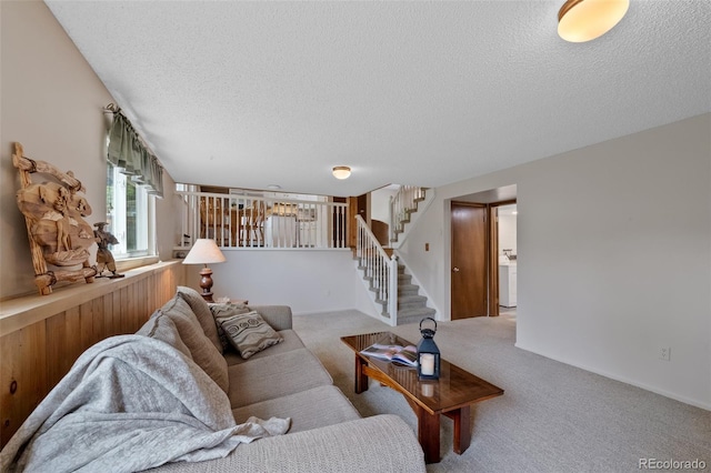 4525 S Cole Ct, Morrison, CO 80465 - carpeted living room with stairs, a textured ceiling, and washer / clothes dryer