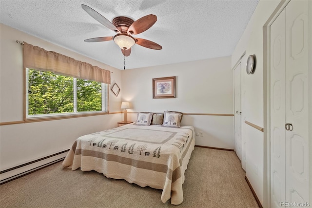4525 S Cole Ct, Morrison, CO 80465 - carpeted bedroom featuring a baseboard radiator, a textured ceiling, and ceiling fan