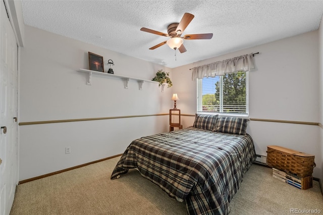 4525 S Cole Ct, Morrison, CO 80465 - carpeted bedroom with a textured ceiling, baseboard heating, a ceiling fan, and baseboards