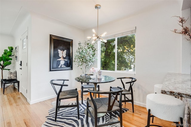 1765 Xenia St, Denver, CO 80220 - dining area with a chandelier, light wood-style flooring, and baseboards