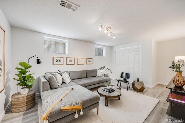 1765 Xenia St, Denver, CO 80220 - living area featuring light wood-type flooring and baseboards