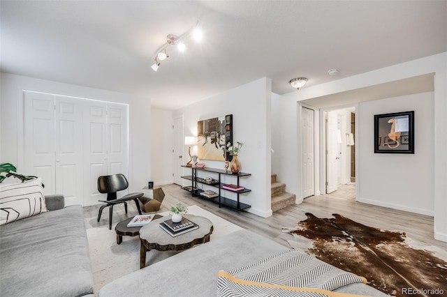 1765 Xenia St, Denver, CO 80220 - living room featuring baseboards, stairway, and light wood finished floors