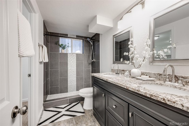 1765 Xenia St, Denver, CO 80220 - bathroom with double vanity, toilet, and tiled shower