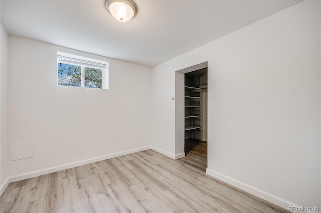 1765 Xenia St, Denver, CO 80220 - unfurnished bedroom featuring light wood-style floors, baseboards, a walk in closet, and a closet