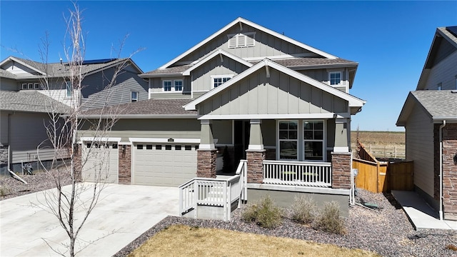 689 Olive St, Broomfield, CO 80023 - craftsman house with a porch, stone siding, a garage, board and batten siding, and driveway