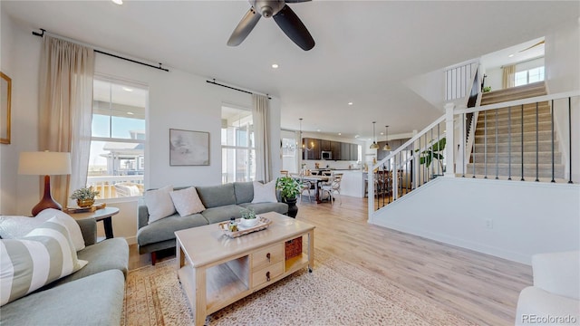 689 Olive St, Broomfield, CO 80023 - living area featuring light wood-style flooring, ceiling fan, recessed lighting, and stairway