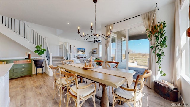 689 Olive St, Broomfield, CO 80023 - dining area featuring recessed lighting, stairway, an inviting chandelier, and light wood-style floors