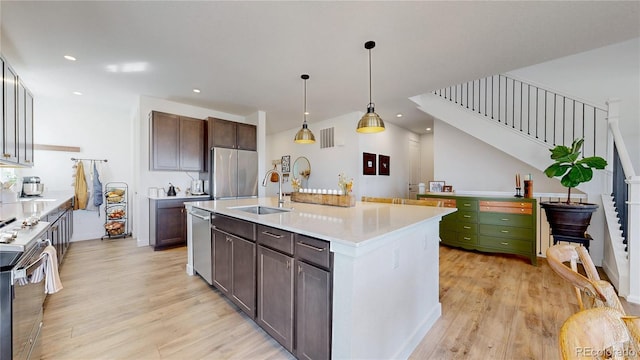 689 Olive St, Broomfield, CO 80023 - kitchen featuring light wood-type flooring, visible vents, light countertops, a sink, and stainless steel appliances