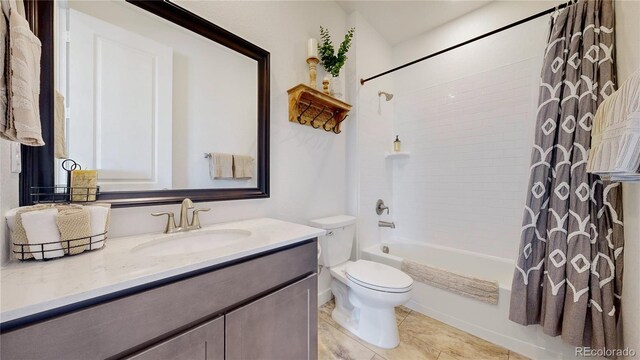 689 Olive St, Broomfield, CO 80023 - full bathroom featuring shower / tub combo, toilet, vanity, and tile patterned floors