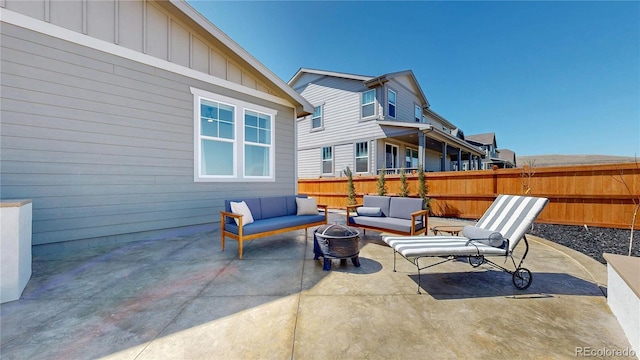 689 Olive St, Broomfield, CO 80023 - view of patio featuring an outdoor living space with a fire pit and fence