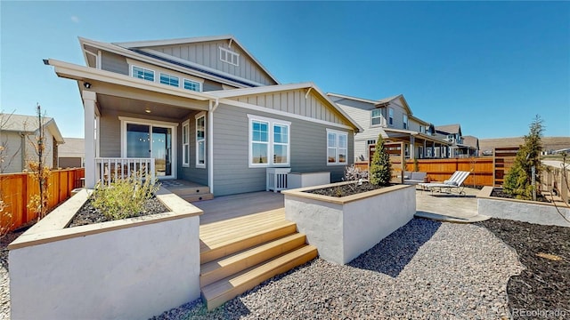689 Olive St, Broomfield, CO 80023 - rear view of property featuring board and batten siding, fence, a patio, and a wooden deck