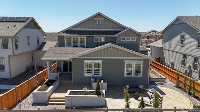 689 Olive St, Broomfield, CO 80023 - rear view of house featuring board and batten siding, a fenced backyard, roof with shingles, a patio area, and central AC unit