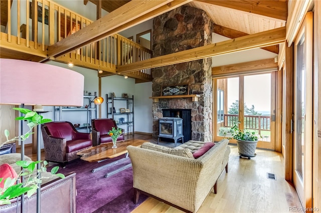 8834 Deiffendeffer Rd, Rye, CO 81069 - living room with wood finished floors, beamed ceiling, high vaulted ceiling, and a wood stove