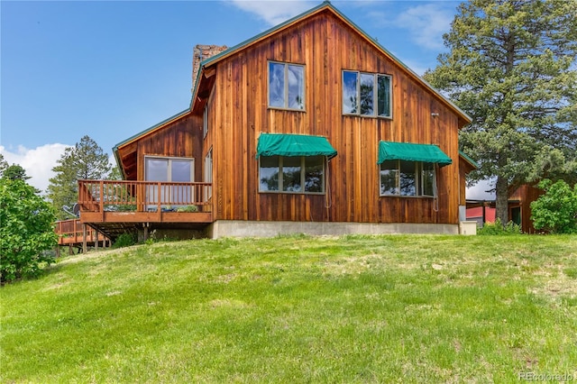 8834 Deiffendeffer Rd, Rye, CO 81069 - view of side of property featuring a chimney, a lawn, and a wooden deck