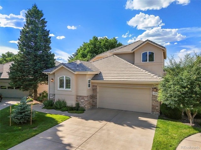 10793 Alcott Way, Denver, CO 80234 - view of front of house with stone siding, driveway, and stucco siding