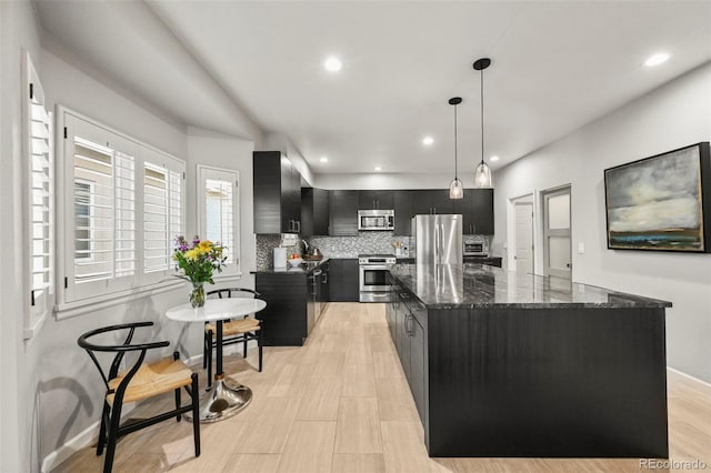 10793 Alcott Way, Denver, CO 80234 - kitchen with dark cabinets, appliances with stainless steel finishes, tasteful backsplash, a kitchen island, and recessed lighting