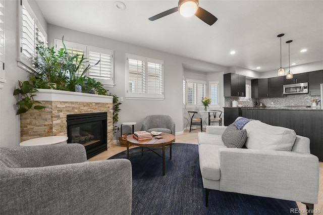 10793 Alcott Way, Denver, CO 80234 - living area with ceiling fan, a fireplace, and recessed lighting