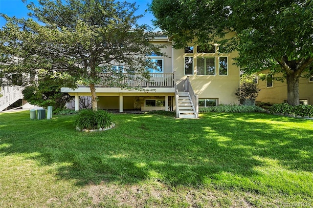10793 Alcott Way, Denver, CO 80234 - back of house with stairs, a deck, stucco siding, and a yard
