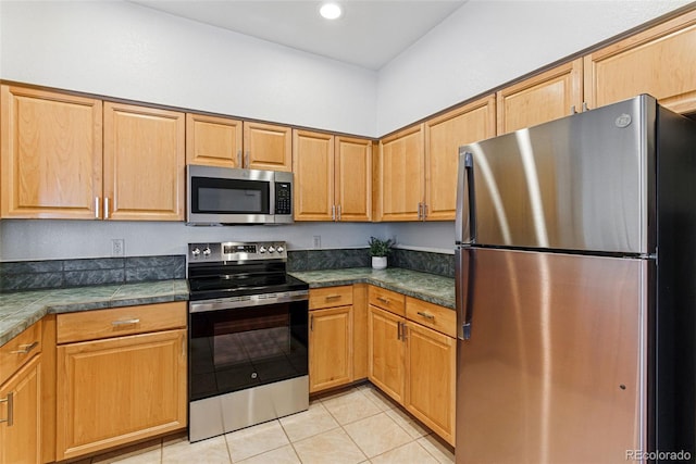 kitchen featuring light tile patterned floors, stainless steel appliances, and recessed lighting