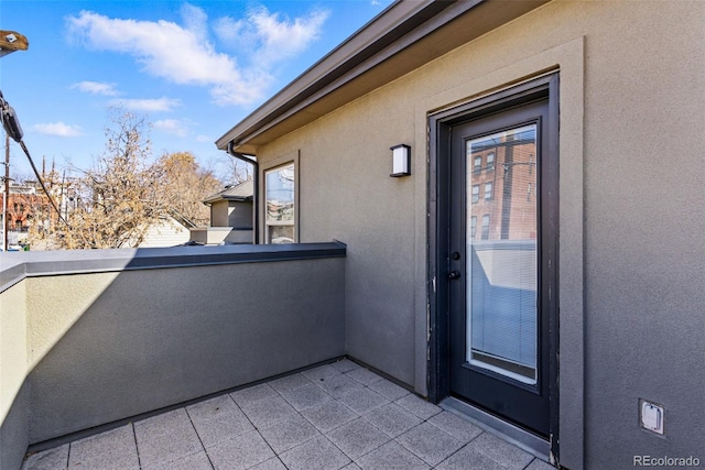 exterior space featuring stucco siding and a balcony