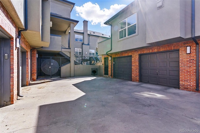 exterior space with concrete driveway and an attached garage