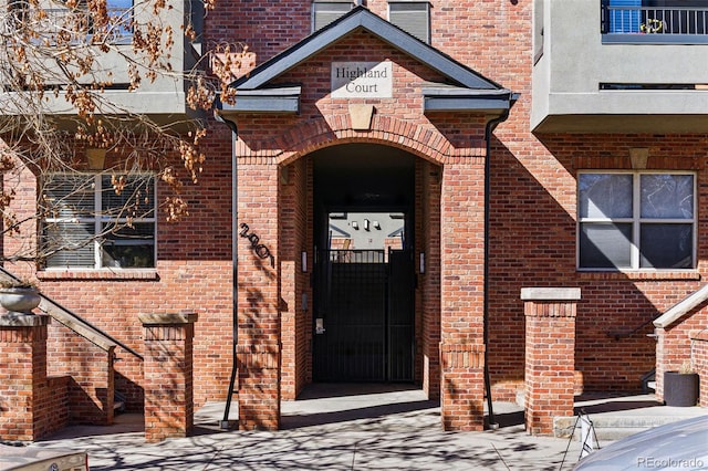 view of exterior entry with brick siding