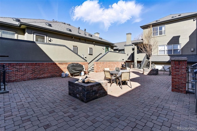 view of patio with outdoor dining area and an outdoor fire pit