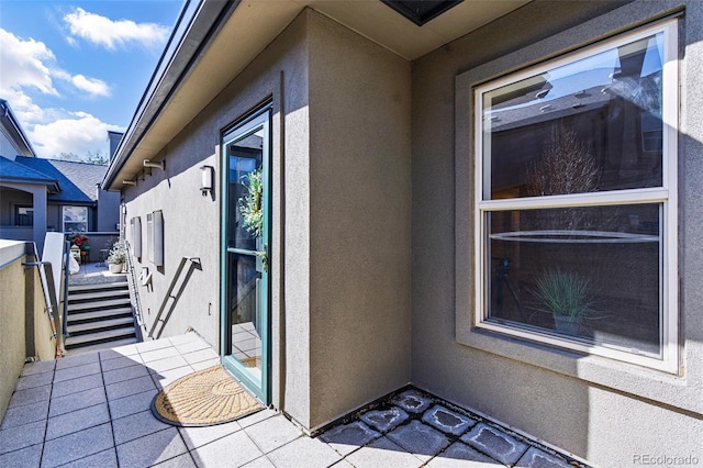 doorway to property with stucco siding