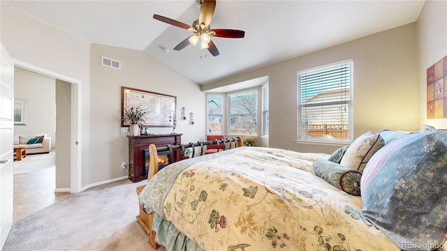 bedroom with visible vents, baseboards, lofted ceiling, light carpet, and a ceiling fan