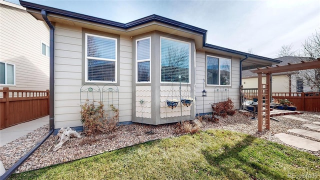 view of property exterior featuring fence