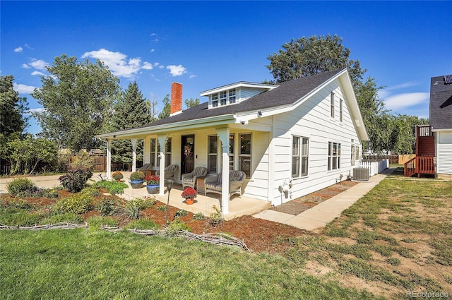 view of front of property featuring central AC and a front lawn