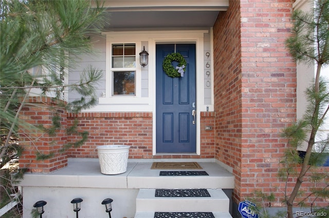 entrance to property with brick siding