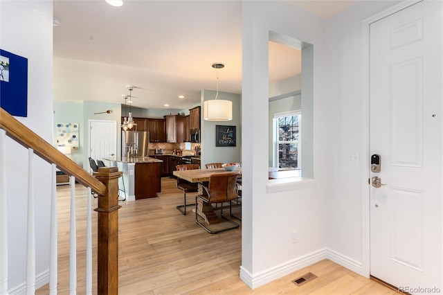 entrance foyer with light wood-style flooring, recessed lighting, visible vents, baseboards, and stairway