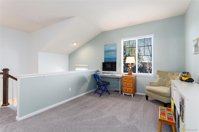 carpeted office space with lofted ceiling and baseboards