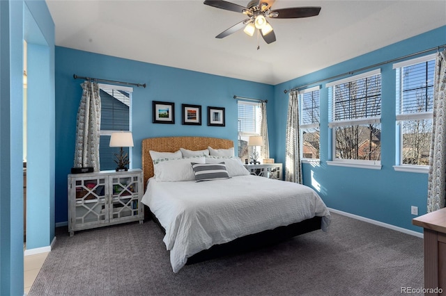 carpeted bedroom featuring ceiling fan and baseboards