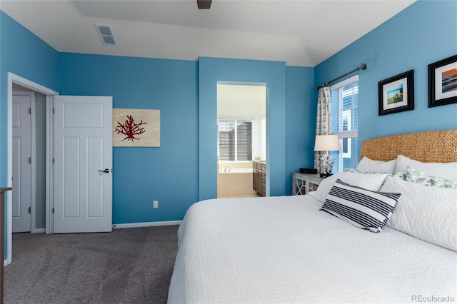 carpeted bedroom featuring a ceiling fan, ensuite bath, visible vents, and baseboards