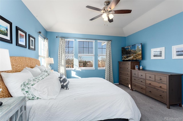 carpeted bedroom featuring lofted ceiling and a ceiling fan