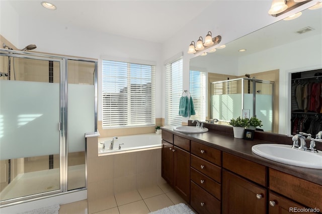 bathroom with a bath, a shower stall, visible vents, and a sink