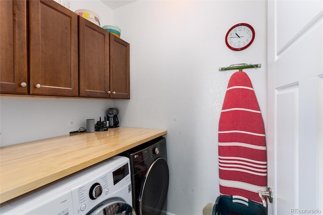 clothes washing area with washer and clothes dryer and cabinet space