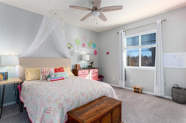 carpeted bedroom with ceiling fan and baseboards