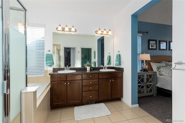 ensuite bathroom with a shower stall, double vanity, a sink, and connected bathroom