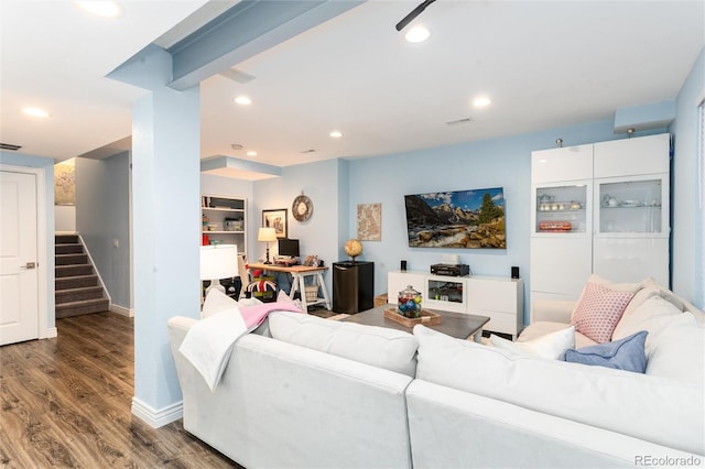 living room with recessed lighting, visible vents, wood finished floors, baseboards, and stairs