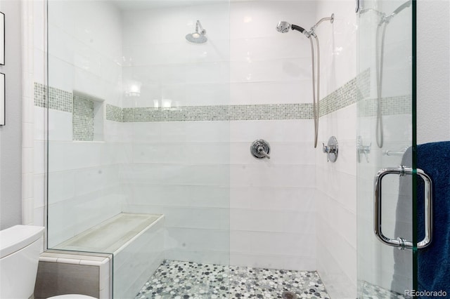 full bath with a stall shower and toilet