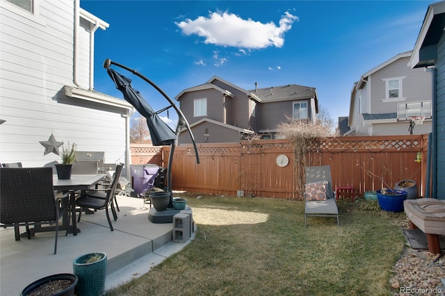 view of yard featuring outdoor dining area, a patio area, and fence