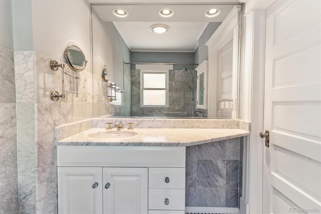 full bath with walk in shower, tile walls, recessed lighting, and vanity