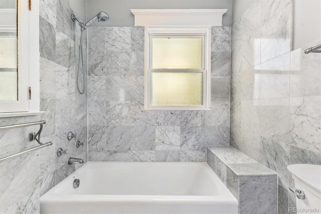 bathroom featuring  shower combination and tile walls