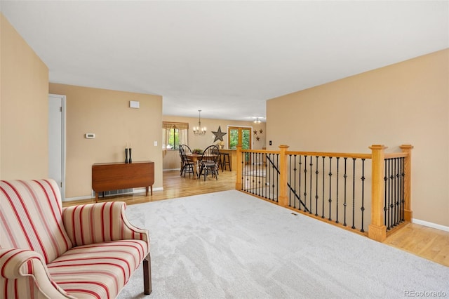 2871 Humboldt Cir, Longmont, CO 80503 - living area featuring a chandelier, wood finished floors, and an upstairs landing