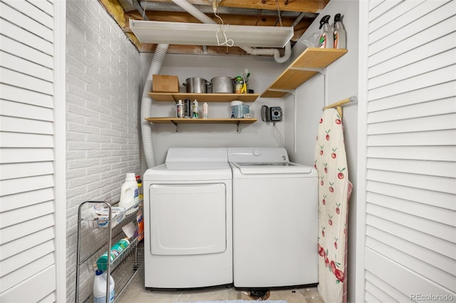 2871 Humboldt Cir, Longmont, CO 80503 - laundry room featuring brick wall and washer and clothes dryer